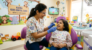 A friendly pediatric dentist in Kasba performing a gentle dental checkup on a smiling child.
